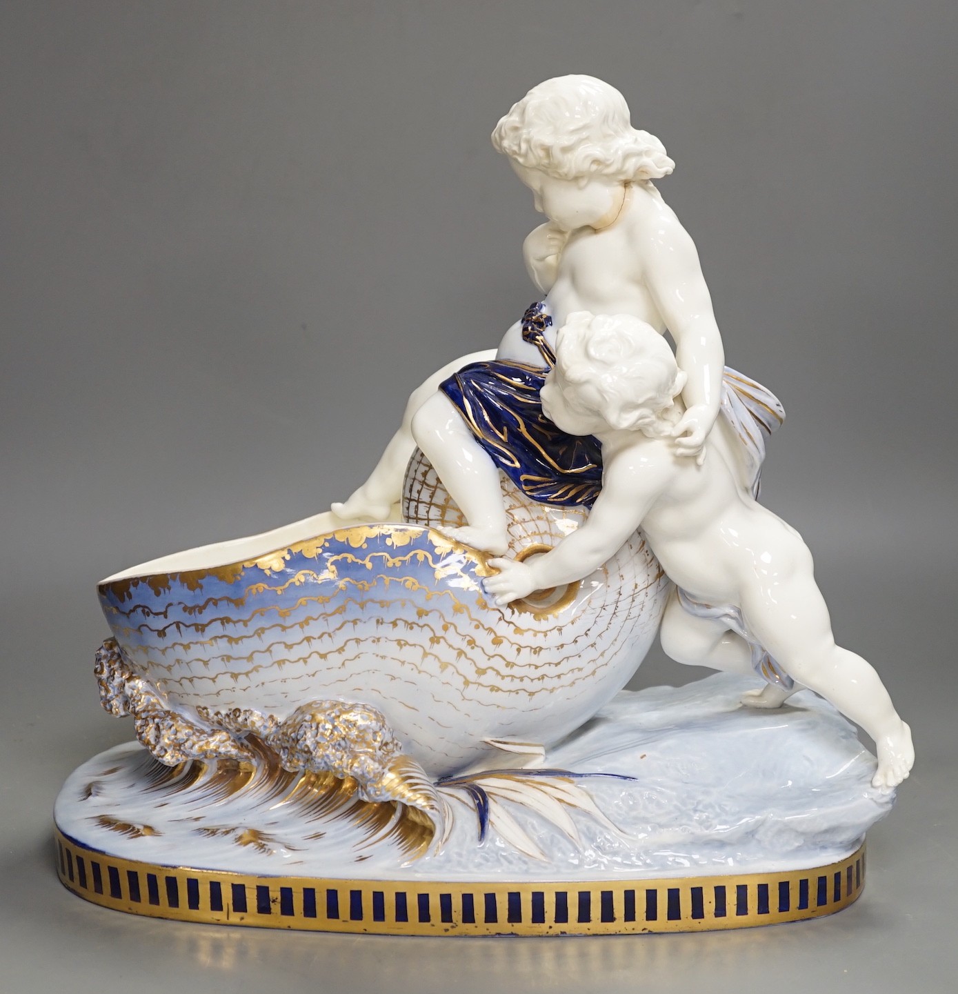 A Copeland porcelain putti seated on a shell centrepiece, modelled O. Hale, c.1877, 35cms high